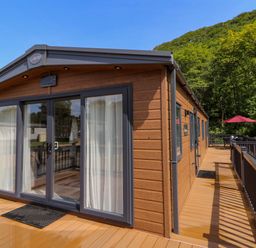 A cabin with sliding doors and a deck at The Beaumont No 34 New Quay