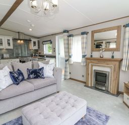 A living room with a sofa and television at The Beaumont No 34 in New Quay