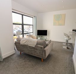 A living room with a sofa and television at Harbour View in Whitehaven