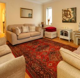 A living room with furniture and decor at Fairways House in Weymouth