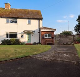A house with a pathway and garden at Bari House in Seahouses