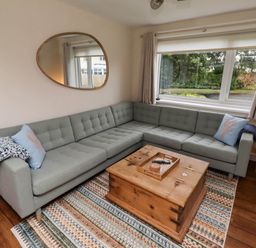 A living room with a sofa and coffee table at Bari House in Seahouses