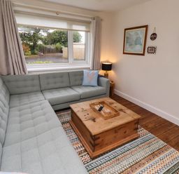 A living room with a sofa and coffee table at Bari House in Seahouses