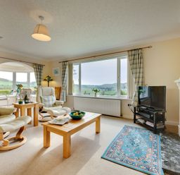 A living room with two armchairs and a coffee table at The Granary in Alnwick