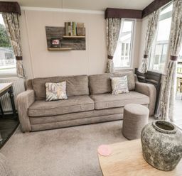 A living room with a sofa and dining table at Kelly's Retreat in Scarborough