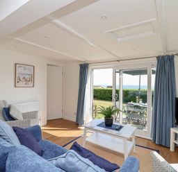 A living room with a sofa and television at Stella Maris in Torpoint