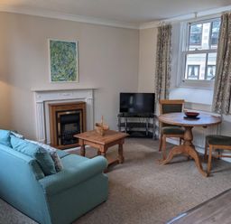 A living room with a sofa and coffee table at Horseshoe Cottage Budock Water near Falmouth