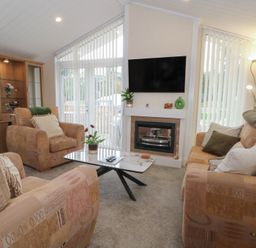 A living room with sofas and a television at Labernum in Lytham St. Annes