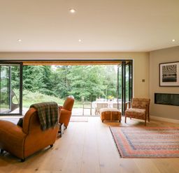 A living room with chairs and a table at Lakeside Lodge in Witherenden Hill near Burwash
