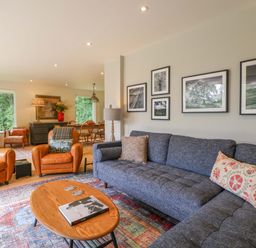 A living room with a sofa and armchairs at Lakeside Lodge Witherenden Hill near Burwash