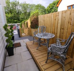 An outdoor space with a table and chairs at Pinecroft Annex Stepaside near Saundersfoot