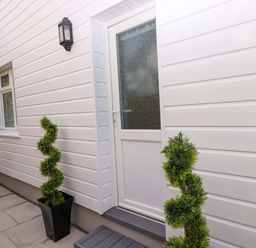 An entrance with a door and windows at Pinecroft Annex Stepaside near Saundersfoot
