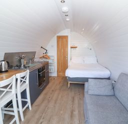 A studio with a kitchen area and bed at New Pod in Kilkhampton