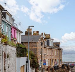 A street view with houses and signs at Captains Cottage in Brixham