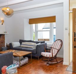 A living room with a sofa and coffee table at Captains Cottage in Brixham