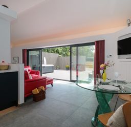 A living room with a dining area at Noflash Malpal in Bishop Sutton