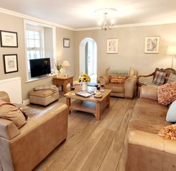A living room with sofas and a coffee table at Bush Nook House in Brampton, Cumbria