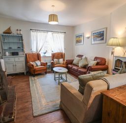 A living room with sofas and a coffee table at Buttercup in Blakeney, Norfolk