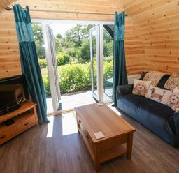 A living room with a sofa and TV at Lodge 2 near Pontyates