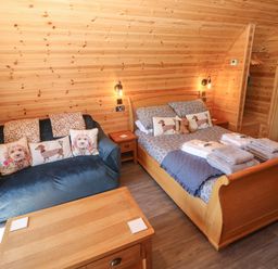 A bedroom with a bed and a sofa at Lodge 3 near Pontyates