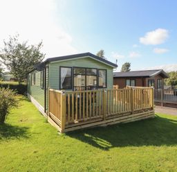 A holiday home with a deck in an outdoor area at Barnes Retreat in Carnforth
