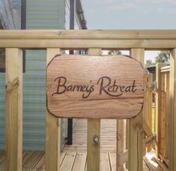 A wooden sign at the entrance of Barnes Retreat in Carnforth