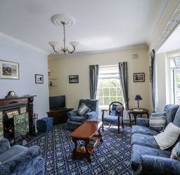 A living room with sofa and TV at Knockroe Lodge in 