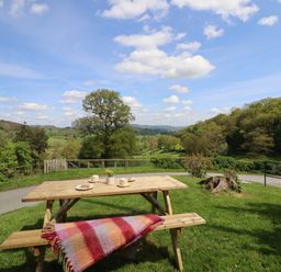 A picnic table with cups and plates at Upper Pandy Farm Berriew near Welshpool