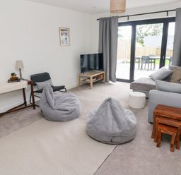 A living room with a sofa and television at Ty Landsker in Houghton near Neyland