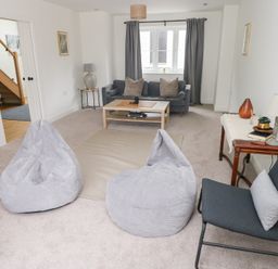 A living room with bean bags and a sofa at Ty Landsker Houghton near Neyland