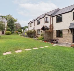 An outdoor area with houses and garden features at Acorns in Falmouth