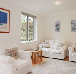 A living room with sofas and a coffee table at Acorns in Falmouth