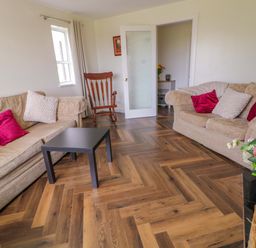 A living room with sofas and a table at Ard Na Mara 