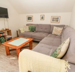 A living room with a sofa and coffee table at Five Elements Barn in Truro