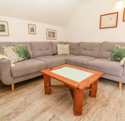 A living room with a sofa and coffee table at Five Elements Barn in Truro