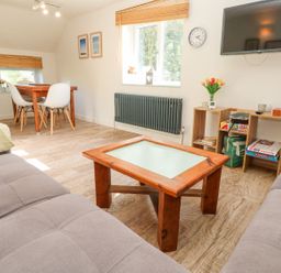 A living room with a table and chairs at Five Elements Barn in Truro
