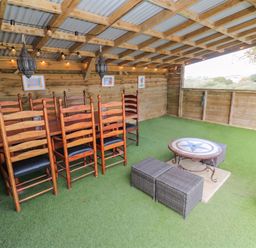 An outdoor dining area with a table and chairs at Five Elements Barn in St Agnes