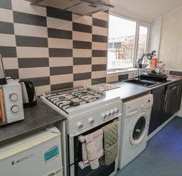 A kitchen with appliances and cabinets at 170 Victoria Road