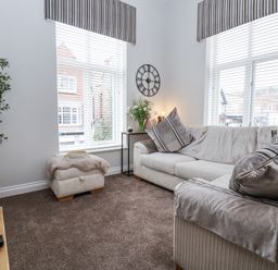 A living room with a sofa and plant at No 2 Emporium Apartments in Prestatyn