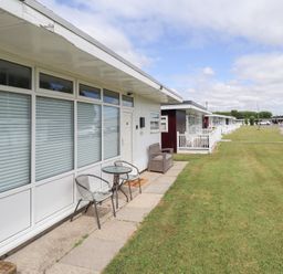 An outdoor area with a table and chairs at 66 Cherry Park in Skegness