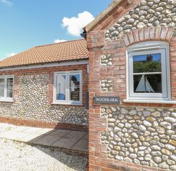 A house with a pathway and windows at Woodlark