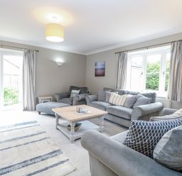 A living room with a coffee table and sofas at Woodlark