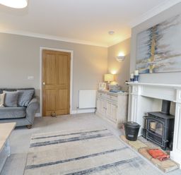 A living room with a sofa and fireplace at Woodlark