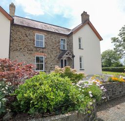 A house with a garden and flowers at The Sycamores in Llawhaden near Narberth