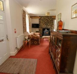 A living room with a sofa and television at The Sycamores in Llawhaden near Narberth