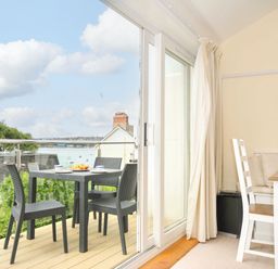 A dining area with outdoor table and chairs at 9 Slipway Cottages Rock