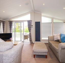 A living room with a sofa and television at The Maples 44 in St. Austell