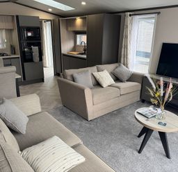 A living room with a sofa and coffee table at Lime Tree Lodge