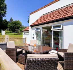 A patio area with seating and a table at Boo’s Bungalow in Callington near Gunnislake