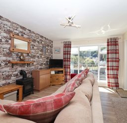 A living room with a sofa, television and coffee table at Boo’s Bungalow in Callington near Gunnislake